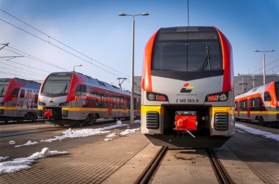 Newag Impuls 2 trainset seen from the front at the depot, with more ŁKA trains in the background